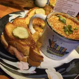 Grilled hot ham and cheese with a mug of chili